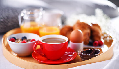 A tray with breakfast on a bed in a hotel room