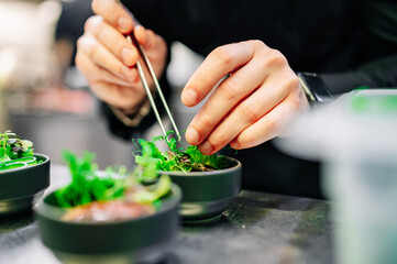 Chef cooking vegetables salad on restaurant kitchen