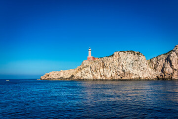 Fototapeta na wymiar The lighthouse Faro Di Punta Carena, Anacapri on the southwest cape of the island of Capri, Italy