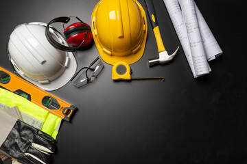 Work safety. Construction site protective equipment on wooden background, flat lay, copy space, top view
