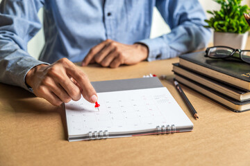 Businessman agenda calendar and reminder agenda work online at home men plan daily appointments and vacation travel journals in a diary at their desk . calendar reminder event concept .