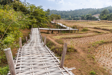 Fototapeta na wymiar Pai Buddha bamboo bridge or Boon Ko Ku So stretches 800 meter long split-bamboo walkway across rice fields and up to a small temple.