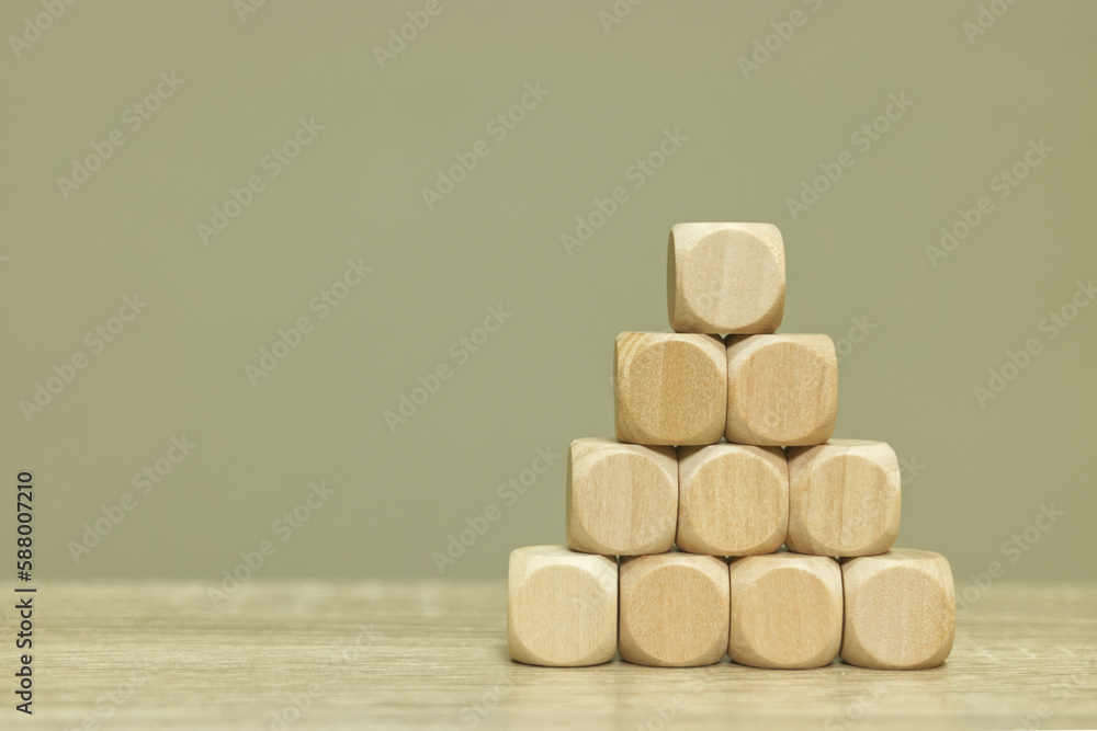 Poster blank wooden cubes arranged in pyramid shape on table for input wording and infographic icon.