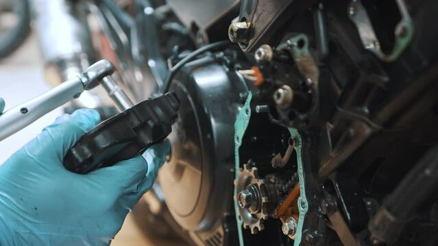 Tightening screws on the motorcycle transmission box. High quality 4k footage