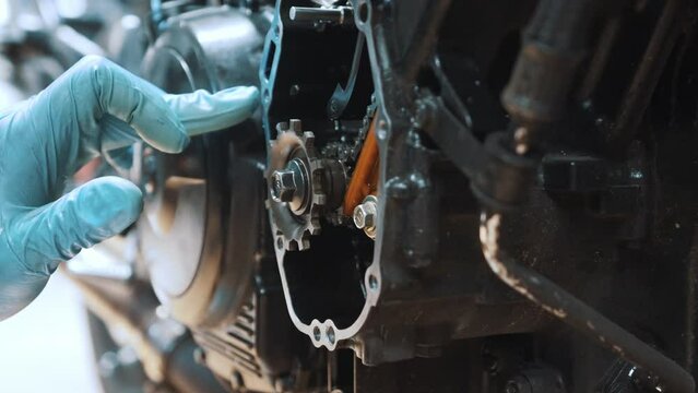 motorcycle gear box refurbishment. Close up on hand removing excess oil from the frame. High quality 4k footage