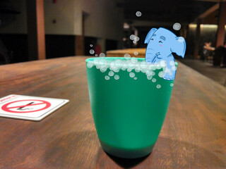 Blue Elephants soaking in green plastic cups.