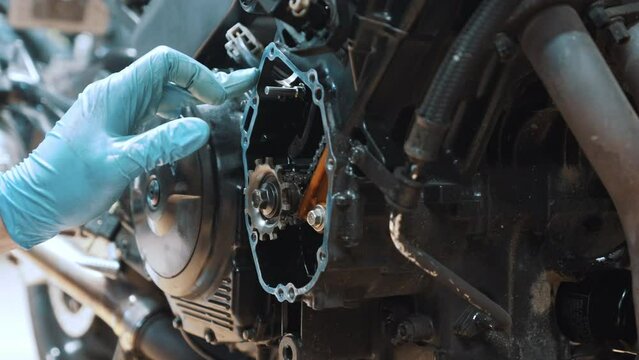  Close up on hand removing excess oil from the frame. Motorcycle gear box refurbishment. High quality 4k footage