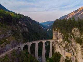Papier Peint photo Viaduc de Landwasser Aerial view of the famous red train on the Landwasser Viaduct, Switzerland.