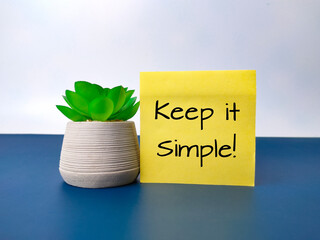 Green plant and sticky note with the word Keep it simple