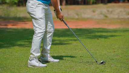 Golfer playing golf in the evening golf course, on sun set evening time