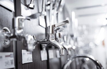 Rows of metal water taps at the showroom of a large store