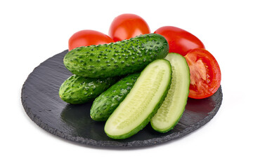 Cucumbers and tomatoes, close-up, isolated on white background.