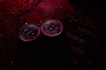 Dark red photo of a Bitcoin coin placed on a computer motherboard. Symbolizing cryptocurrency mining, blockchain technology, and the digital economy. Perfect for fintech or crypto themes.