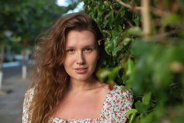 Portrait of beautiful young woman in dress is enjoy summer or spring day on natural green natural...