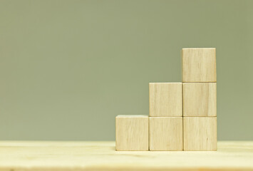 Blank wooden cubes arranged in stairs shape on table for input wording and infographic icon.