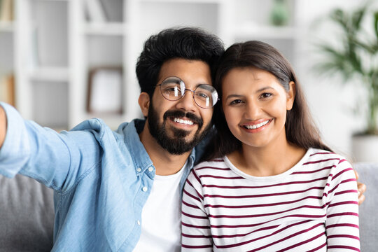 Portrait of loving happy beautiful mixed race couple, home interior