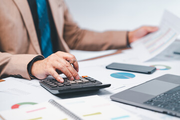 businessman is meticulously calculate financial projections, marketing strategies while working on...