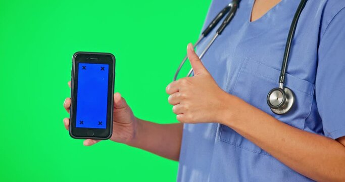Green screen, phone and hands of doctor with thumbs up, pointing and okay sign for mobile app mockup. Healthcare, digital and woman nurse with smartphone for wellness, medical service and telehealth