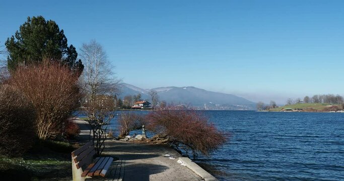 Blick auf den Tegernsee und seine leicht bewegten Gew&auml;sser unter blauem Himmel vom Seepromenade in Rottach-Egern
