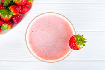 Strawberry mix banana smoothies juice beverage healthy the taste yummy In glass drink episode morning on wooden background from the top view.