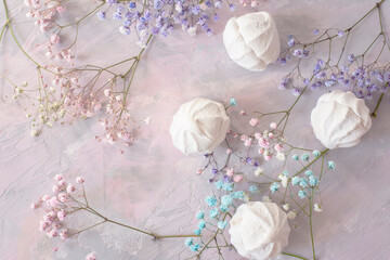   delicate pink small flowers and a tender dessert white marshmallow on a gentle gray-pink...
