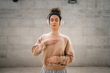woman caucasian female using headphones for online guided meditation