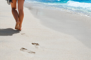 beautiful traces with feet near the sea on nature background