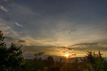 tropical sunset on a plain with trees
