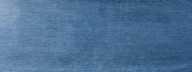Blue denim jeans texture banner with copy space for text design background. Canvas denim fashion texture. Panoramic fashion banner