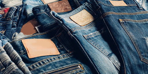 Stack of various shades blue jeans. Jeans stacked isolated on white background. Blue denim jeans...