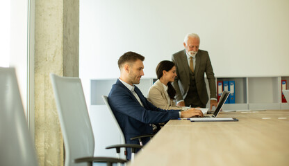 Young business man using laptop computer in the office