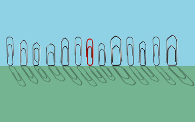 Still-life with one red paperclip among others metal paperclips