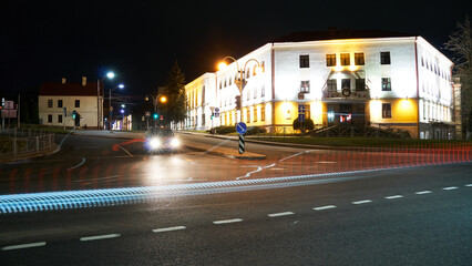 Night city light lines from cars. cars in highway with blur motion. Street view of the modern city at night. A lot of light from car headlights, advertising banners and night lights.