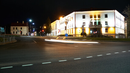 Night city light lines from cars. cars in highway with blur motion. Street view of the modern city at night. A lot of light from car headlights, advertising banners and night lights.