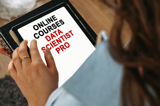 A woman holds a tablet in her hands on the screen of which it is written - online courses Data Scientist PRO