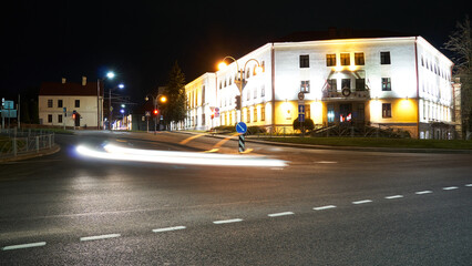 Night city light lines from cars. cars in highway with blur motion. Street view of the modern city at night. A lot of light from car headlights, advertising banners and night lights.