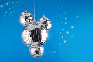 Fototapeta premium Bright shiny mirror disco balls reflecting light. Holidays concept.