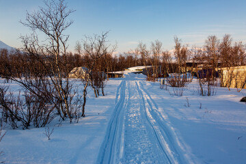 Abisko in Lapland in Sweden. Sunset at frozen Tornetrask Lake. Sun, snow, ice, the Arctic Circle, a landscape of northern Europe