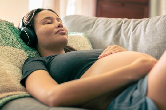 A pregnant woman sleeping at home. Relaxation music and meditation.