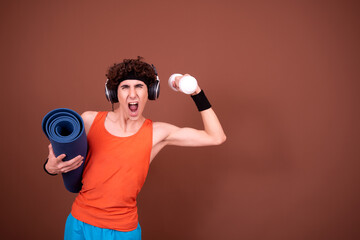 Retro style. A young attractive guy is doing aerobics.