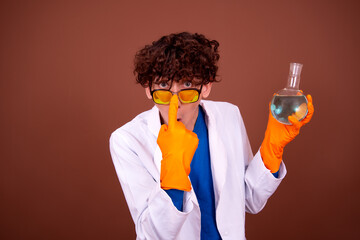 Crazy young scientist makes experiments in the office.
