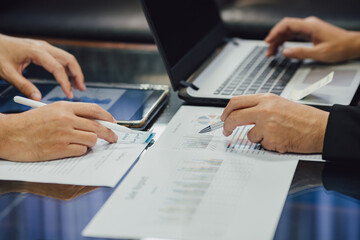 Fototapeta premium Two businessman investment consultant analyzing company financial report balance sheet statement with documents graphs. Concept for marketing strategy and business plan working together.
