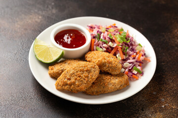 Vegetarian vegan southern fried nuggets served with sweet chilli sauce and cabbage salad
