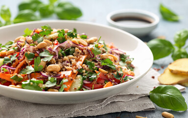 Asian Quinoa salad with fresh vegetables, peanuts and herbs. Healthy food.