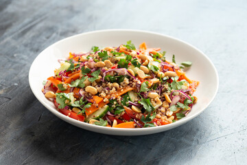 Asian Quinoa salad with fresh vegetables, peanuts and herbs. Healthy food.