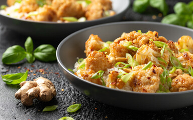 Kung Pao Cauliflower with rice, peanuts and spices. Healthy vegan food.