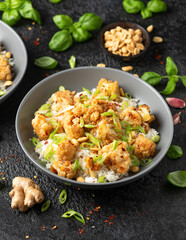 Kung Pao Cauliflower with rice, peanuts and spices. Healthy vegan food.