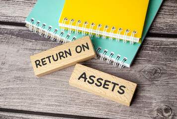 return on assets symbol. Concept words return on assets on wooden blocks.