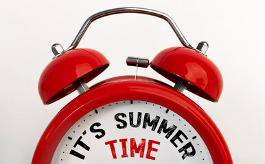 Red alarm clock with text It's Summer Time