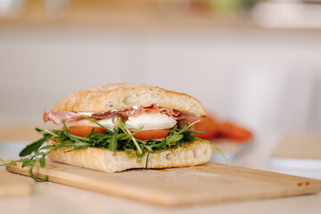 Tasty bruschetta on wooden board. Classic Italian lunch. Baguette with tomatoes, mozzarella and...